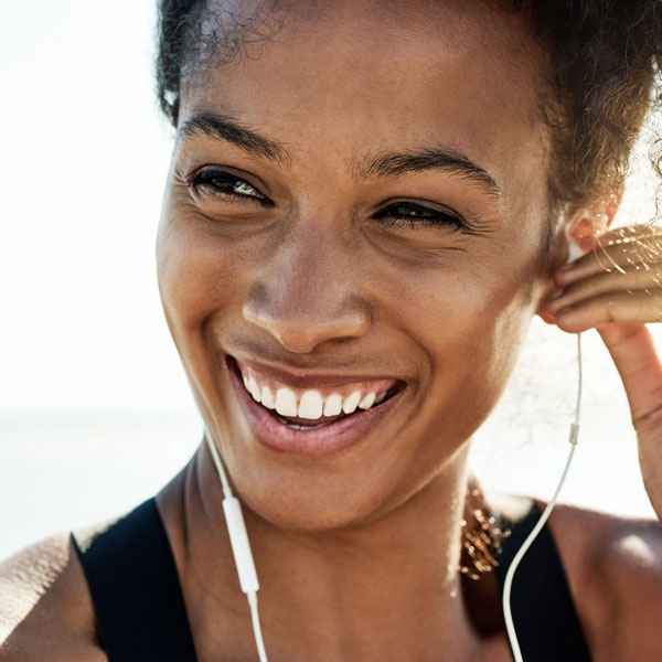 Young woman with a healthy smile after periodontal disease treatment in Wyoming, MI