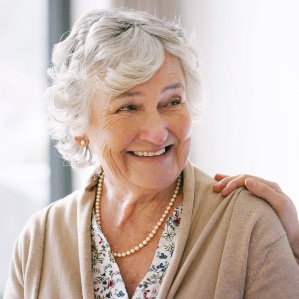 Elderly woman smiling after restorative dental treatment in Wyoming, MI, dental clinic