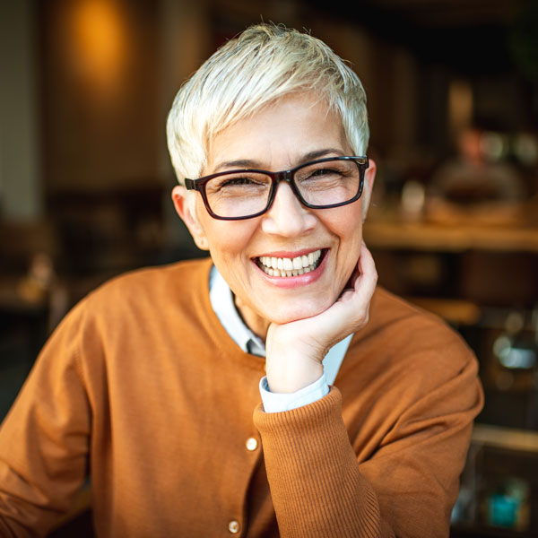 Happy woman after emergency dental treatment for tooth pain in Wyoming, MI